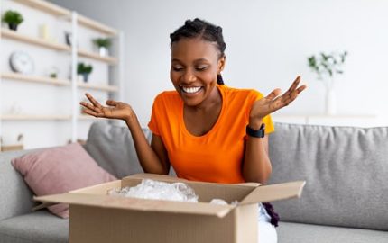 Woman opening a package that was delivered at home